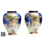 Carlton Ware - A pair of Art Deco vases decorated in the Heron and Magical Bird pattern, printed