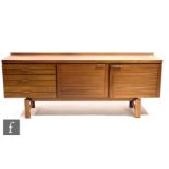 White and Newton - A 1960s teak sideboard with ribbed panel front, fitted with an arrangement of