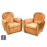 Unknown - A pair of tan leather club armchairs in a distressed finish, raised to beechwood block