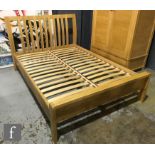 Ercol Furniture - A light oak Bosco range double bed frame, with curved finger joint detailing,