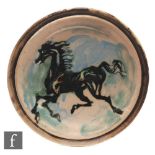 Unknown - A post war stoneware plate of circular form, decorated with a stylised figure of a horse
