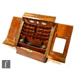 A Victorian figured walnut stationery box, the doors opening to reveal a stepped divisioned interior