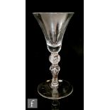 An 18th Century Newcastle style light baluster drinking glass circa 1750, the heavy based bell