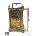 An early 20th Century miniature brass carriage clock, probably French, with bevelled glass panels