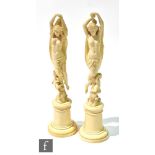 A pair of late 19th Century French carved ivory figures of a pair of semi naked classical dancing