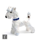 A small 1930s Goldscheider Art Deco figure of a terrier in standing pose wearing a blue collar,