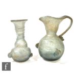 A 1st Century Roman blown glass aqua wine jug mounted with three grape bosses, height 15cm, and a
