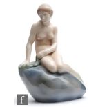 A Royal Copenhagen model of the Little Mermaid sat on a rock, printed mark and painted 4431,