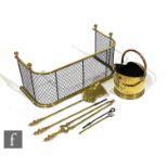 A 19th Century brass rail and mesh fender on ball feet, width 80cm, also a set of three brass fire