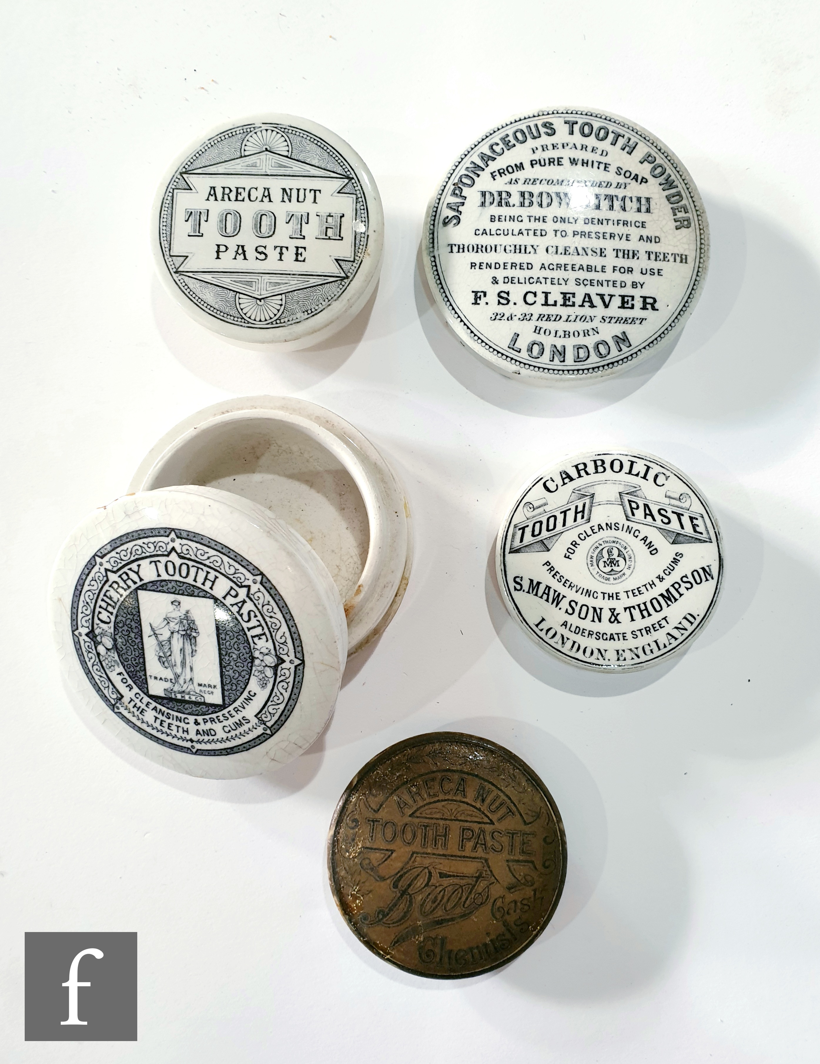 A pictorial Cherry tooth paste jar and lid by S M & Co, a Boots Areca nut lid, a Sapanaceous tooth