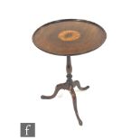 A 19th Century mahogany snap-top wine table of circular form, the top inlaid with a central