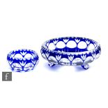 A 20th Century glass bowl, of footed form, cased in blue over clear and flash cut with a band of