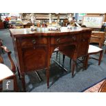 A George III style crossbanded mahogany serpentine front sideboard, fitted with three frieze drawers