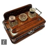 A Victorian two handled oak ink stand fitted with two glass ink wells and an ashtray over a base