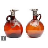 A pair of late 19th Century spirit flasks of compressed ovoid form with collar necks and loop