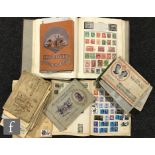 A large world stamp album and two smaller albums containing definitives and assorted Wills cigarette