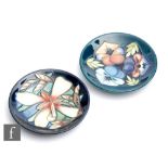 Two Moorcroft Pottery Collectors Club pin dish coasters, the first decorated in the Triple Choice