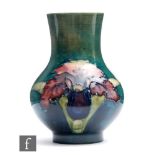 A Moorcroft vase of footed globe and shaft form decorated in the Frilled Orchid pattern, impressed