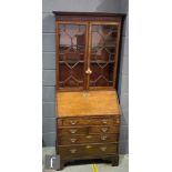 A George III mahogany bureau bookcase of small proportions enclosed by an astragal glazed door