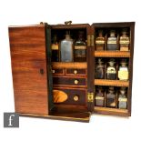 An early 19th Century mahogany apothecary chest, the double hinged front opening to reveal a