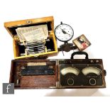 A 1950s cased Revealer (used to calculate the diameter of pipes) with instructions, a cased volt and