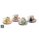 Four Emma Bridgewater coffee cans and saucers, each decorated in the typical manner with sponged