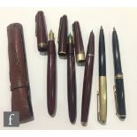 A Parker Duofold fountain pen, a Parker 535 fountain pen, a later Parker pen, all red cased, and