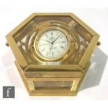 A contemporary Sewills Ark Royal gimbal desk clock, in polished brass and glazed hexagonal case with