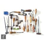 A collection of 19th and early 20th Century leather working tools to include creamers, burnisher,