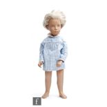A Trendon Sasha Blonde Gingham doll, with short hair cut and wearing blue gingham dress with