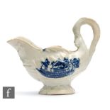 A late 18th Century pearlware cream or sauce boat with a blue and white Chinoiserie scene
