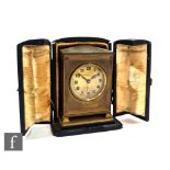 A small Edwardian gilt bedside clock by W Greenwood & Sons Leeds, eight day movement with alarm in