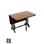 An Edwardian mahogany drop flap Sutherland table on turned legs united by a turned stretcher,