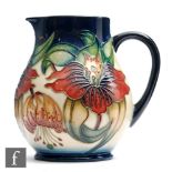 A Moorcroft Pottery jug decorated in the Anna Lily pattern designed by Nicola Slaney, impressed