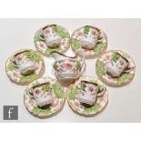 A set of six early 20th Century Coalport Batwing pattern 2665 coffee cups and saucers in green,