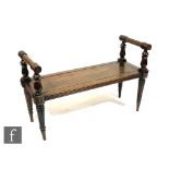 A 19th Century oak window seat or hall bench, with turned and reeded side rails above conforming