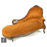 A Victorian carved and pierced mahogany button back chaise longue on cabriole legs, upholstered in