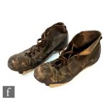 A pair of early 20th Century brown leather football boots, with retail labels inside reading '