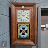 An American mahogany cased eight day wall clock enclosed by a glazed door painted with Red Cross