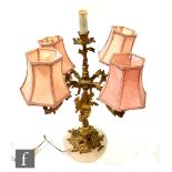 A 20th Century rococo style gilt candelabra on acanthus leaf and alabaster circular base, height