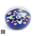 A 1930s Paul Ysart for Monart paperweight, the blue ground dome set with a star formation of