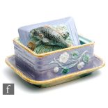 A late 19th Century George Jones majolica sardine box and cover decorated in lavender with moulded