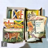 A collection of Brooke Bond tea cards and loose trade cards in two shoe boxes.