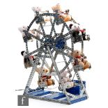 A Meccano model of a ferris wheel built using yellow, blue and zinc pieces, motorised, height 48cm.