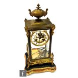 A late 19th Century French gilt metal and bevelled glass regulator mantel clock, the case surmounted