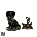 A 19th Century model of a bronze seated dog wearing a bonnet, hinged top opening to reveal a ceramic