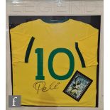 A Brazil No 10 yellow football shirt signed by Pele with photograph, framed 90cm x 80cm.