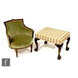 A George III style carved mahogany dressing table stool on scroll carved legs, upholstered in