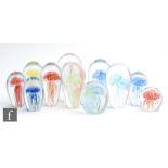 A group of ten 20th Century glass paperweights internally decorated with stylised jellyfish of