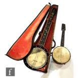 An early 20th Century six string banjo, two strings missing, mother of pearl decoration, cased,